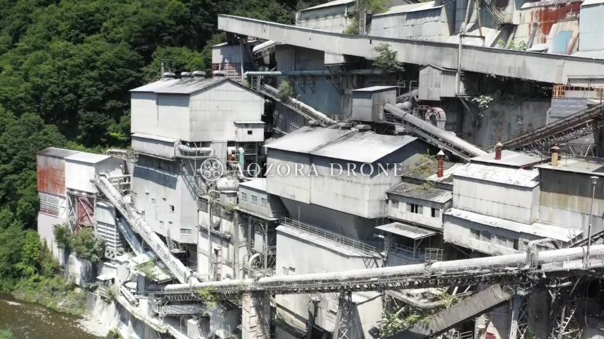 Drone aerial video footage of Okutama Industry Hikawa factory standing in the mountains of Okutama [Tokyo / Okutama Town, Japan]